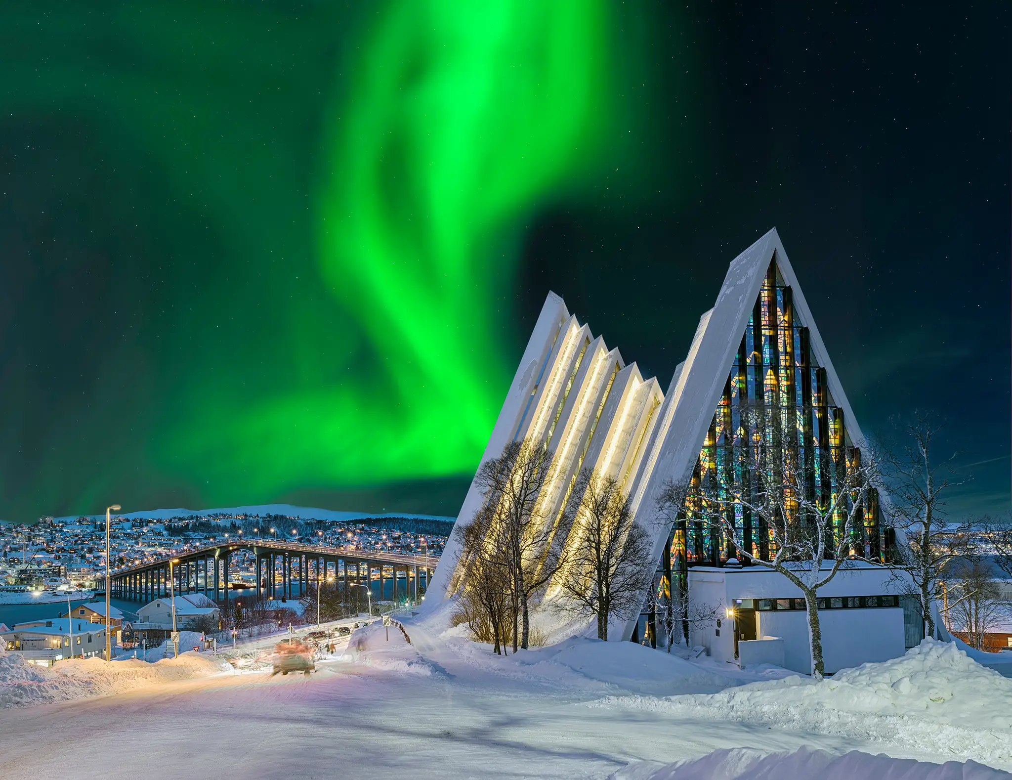 Arctic Cathedral in Tromso at night with aurora borealis in the sky.