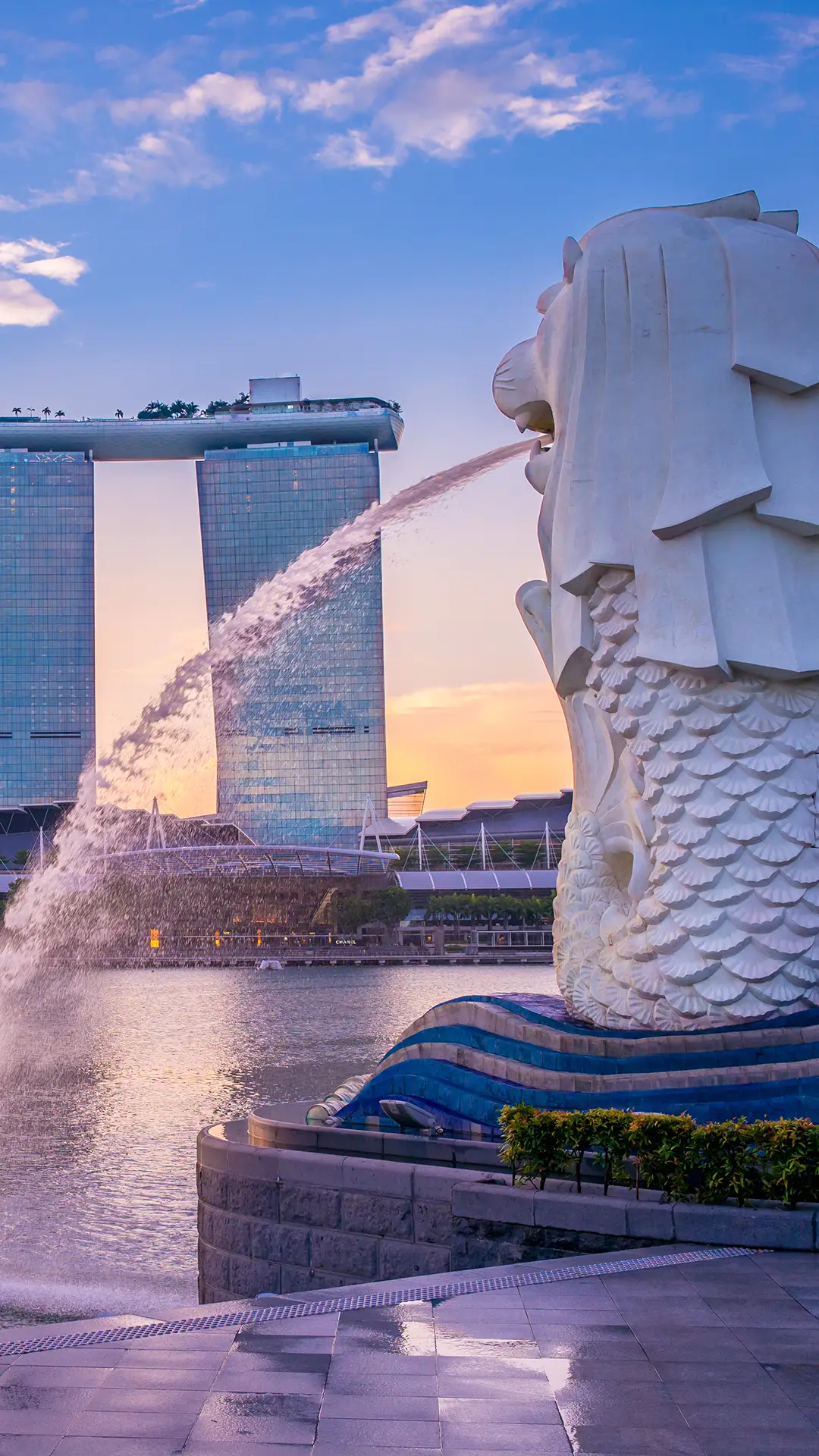 Silhouette of Merlion Statue in Singapore with Marina Bay Sands in the background.