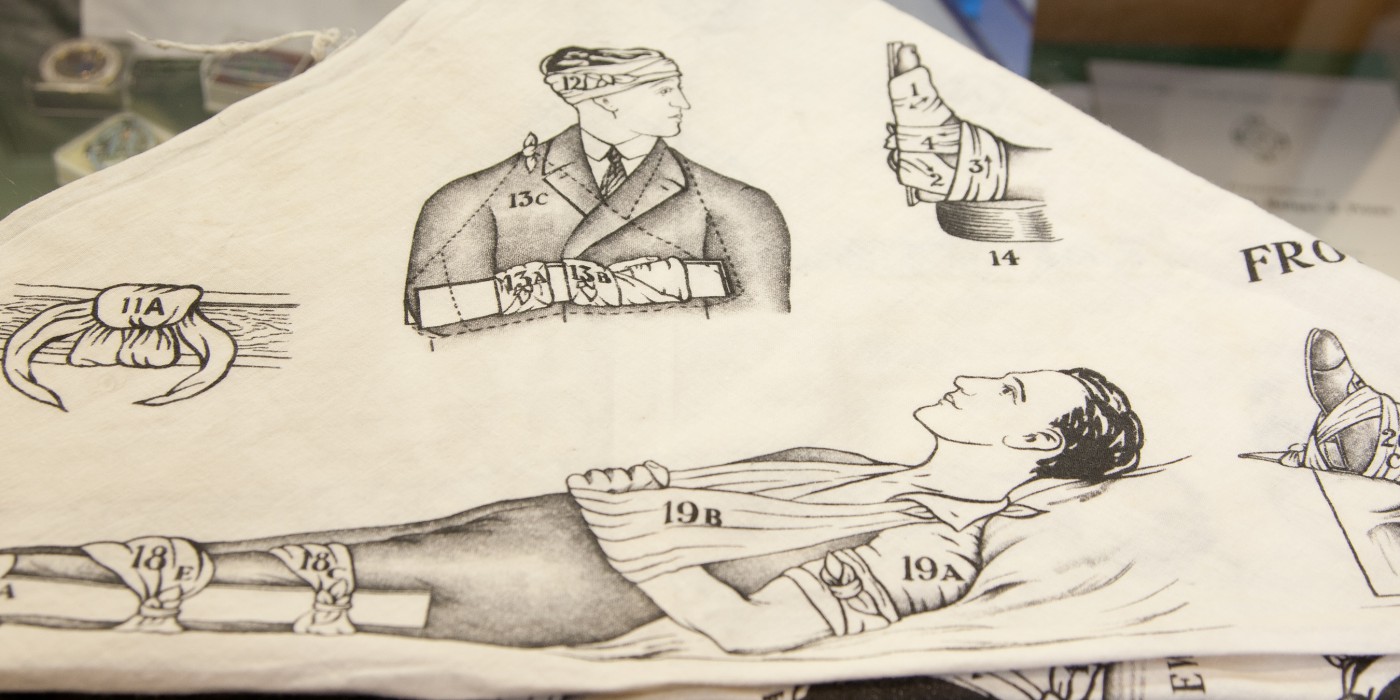 Historic cloth with drawings of men and body parts dressed in bandages.