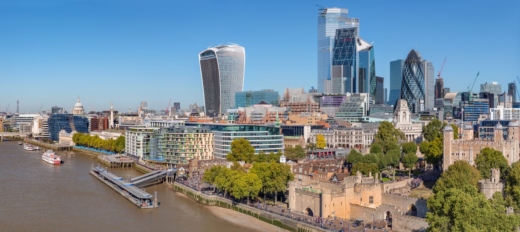 Aerial view of Thames river on a sunny day with the City Financial district skyscrapers and Tower of London