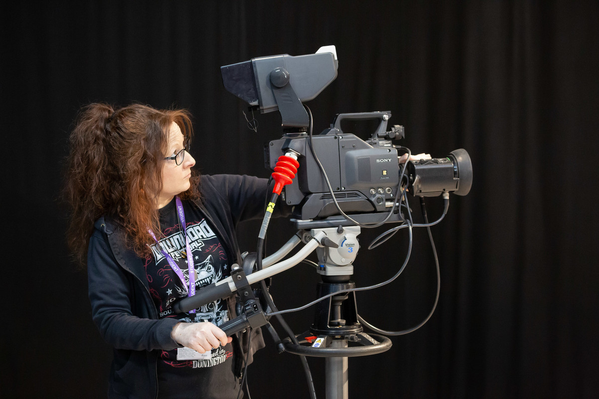 A person using a production recording camera