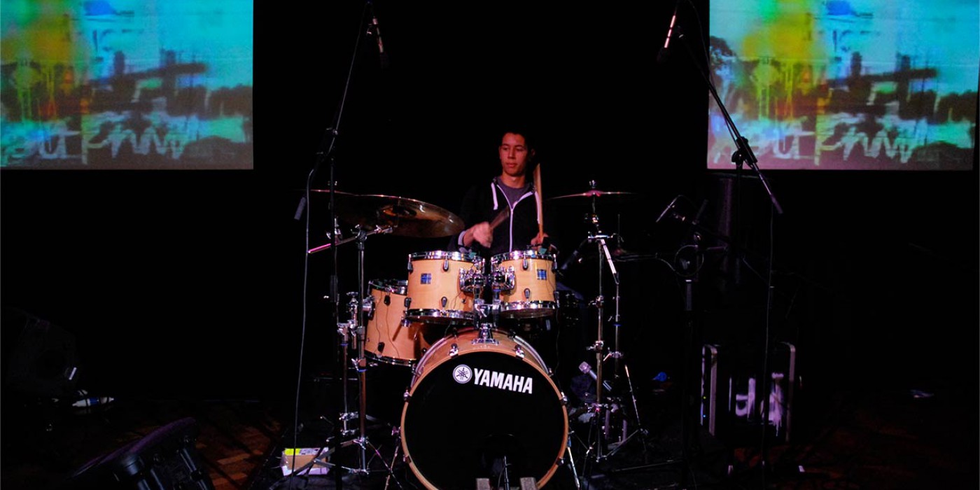 man playing drums on stage