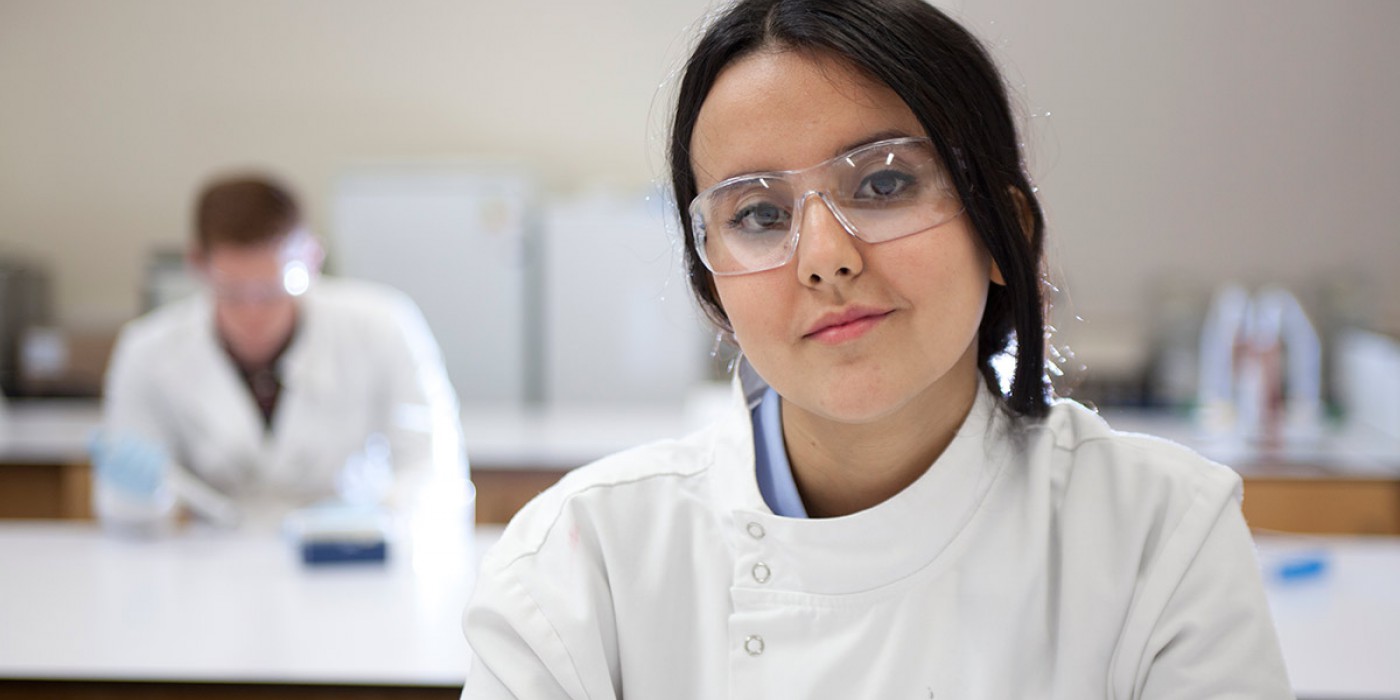 A science student wearing protective glasses