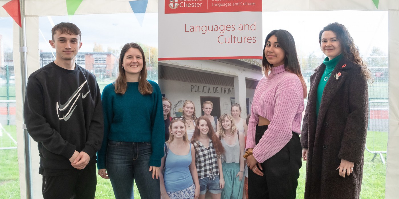 Four students standing before a University of Chester Languages & Culture sign
