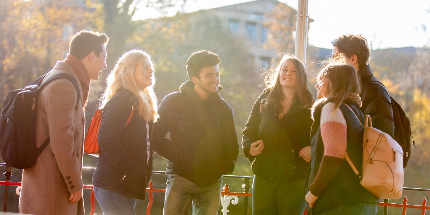 A group of students chatting in the winter sunshine