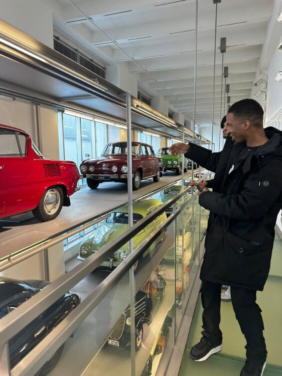 students in skoda factory looking at cars