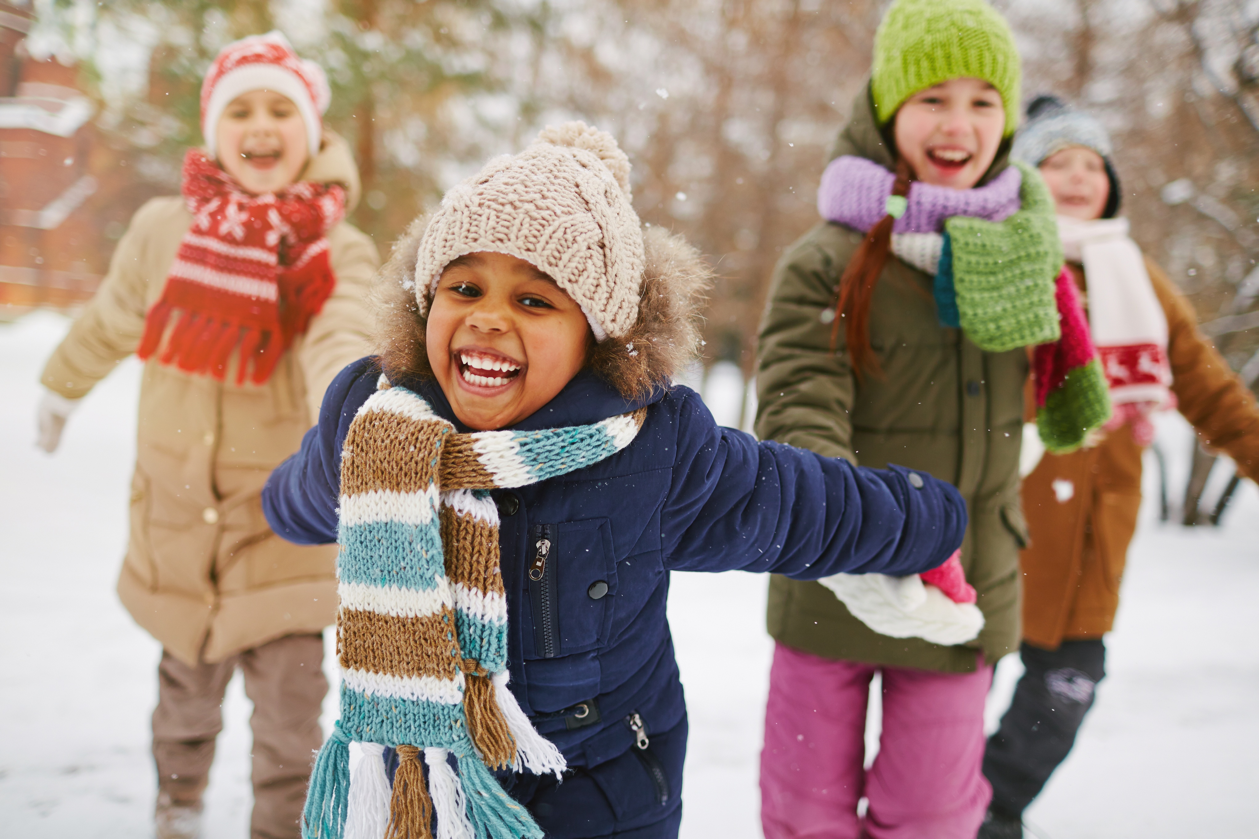 A group of children playing together in snow